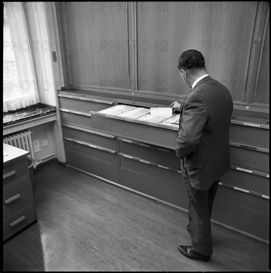 Policeman of the Zurich metropolitan police at the register of prostitutes 1969.