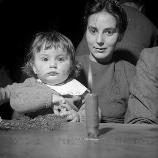 Mother with child at Christmas, 1952.