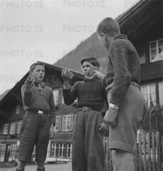 Boys making music with wood pieces, 1943.