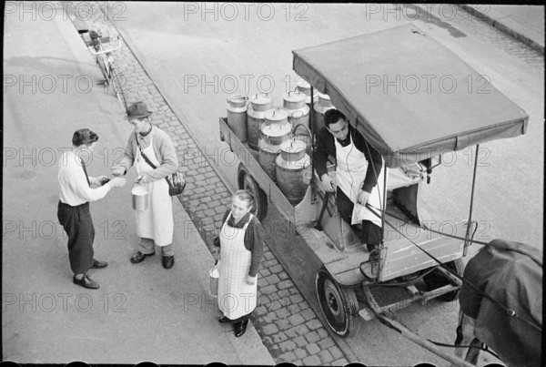 Milkman serving customers; 1941.