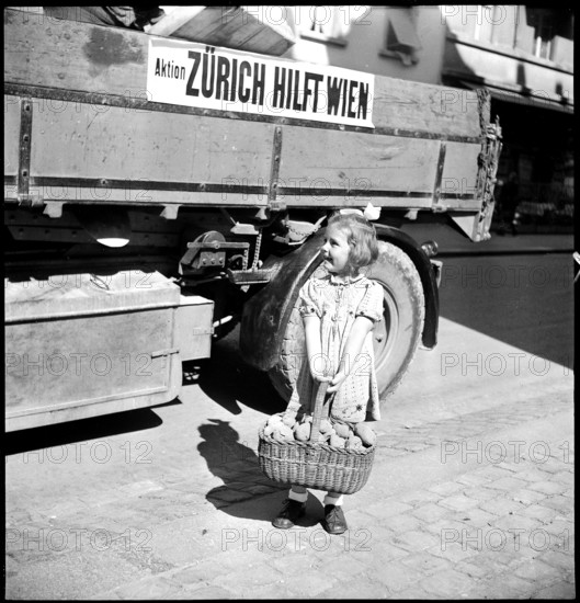 Girl with basket full of potatoes.