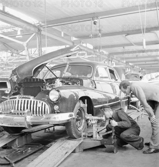 Factory worker; assembling; wheel; assembly hangar; General Motors 1946.