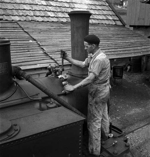 Mechanics repairing a steam locomotive in Les Brenets 1946.