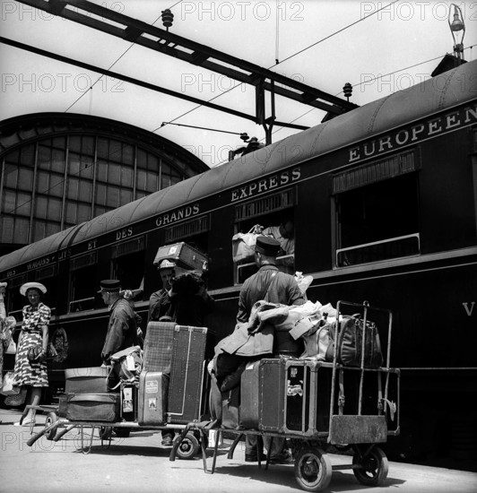 Porters with luggage cars before departure of the Northern Express, 1947.