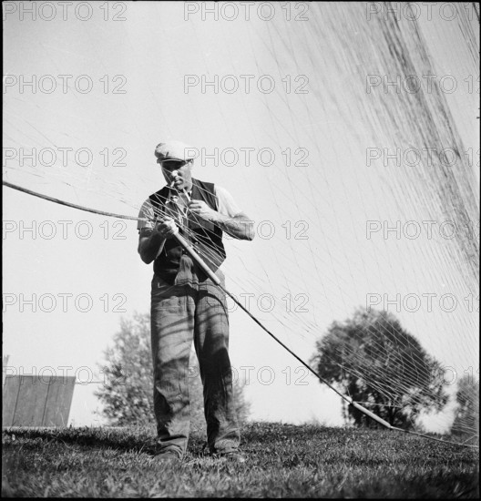 Fisherman from Lake Constance repairing net 1945.