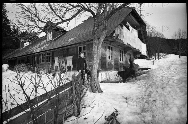 Boy in front of a farm house in the Emmental, 1970.