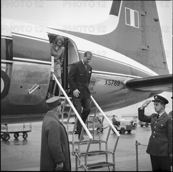 Prince Philip and princess Anne debarking from the aircraft, plane.