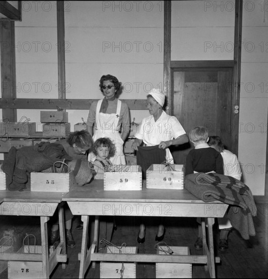 Gina von Liechtenstein dressing Hungarian children, Buchs 1956.