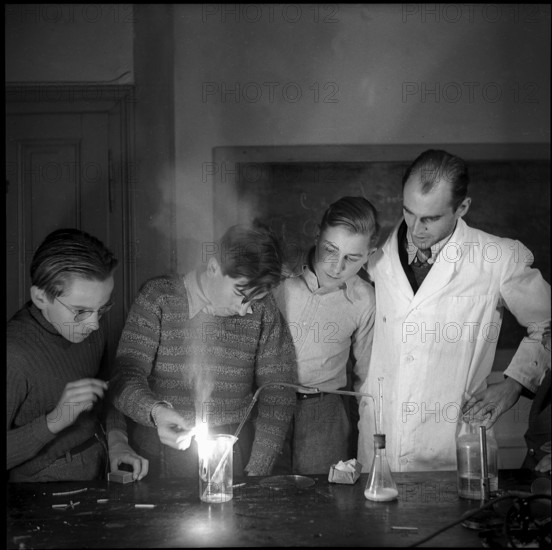 Male Teenagers and Teacher in Chemistry Class.