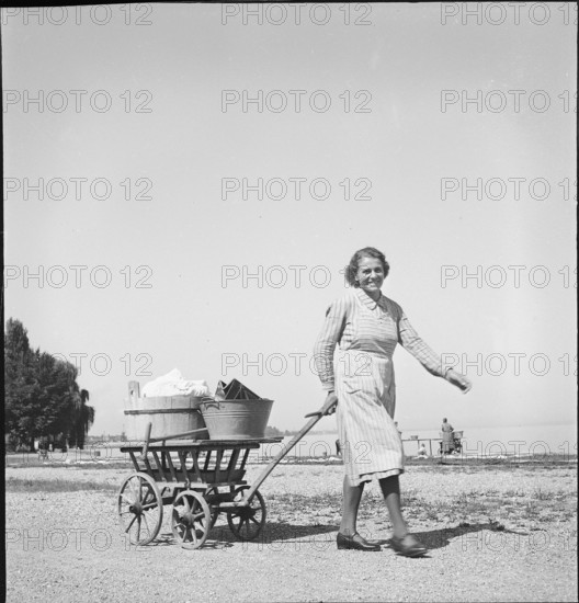 Woman with laundry to wash at Lake Constance, 1944.
