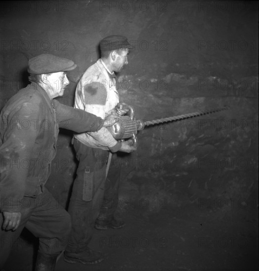Herznach mine, workers prepare for blasting; 1952.