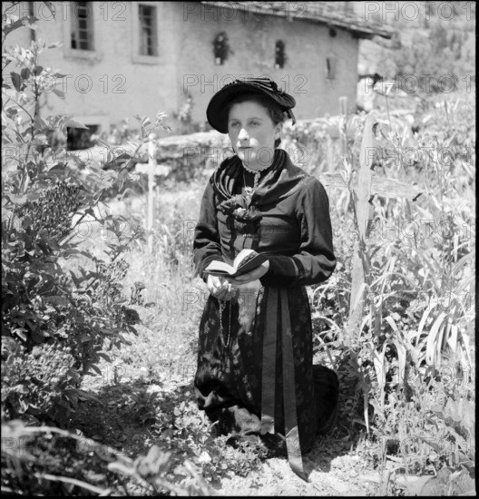 Young woman praying on Corpus Christi in the Valais village Ayent, 1943.