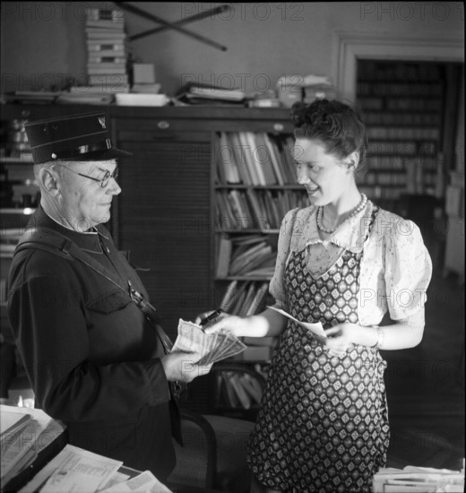 Letter-Carrier Handing over Money, 1943.
