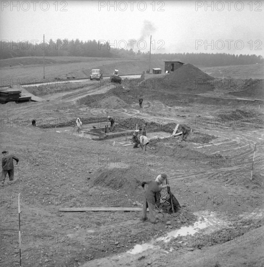 Workers preparing the ground for a drilling derrick; 1958.