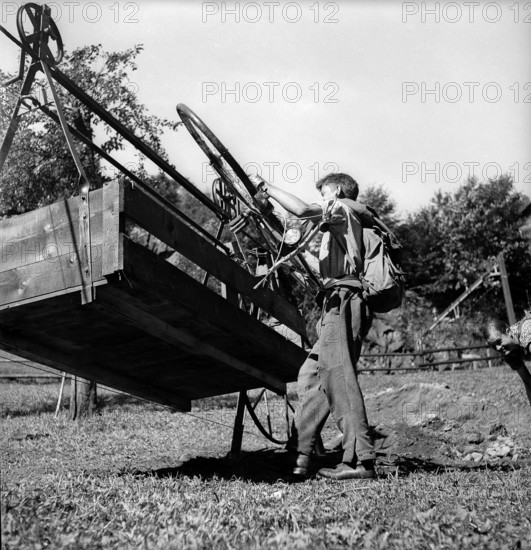 Mountain farmer transporting goods by cableway 1944.