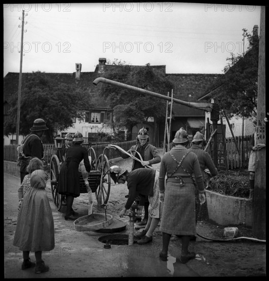 Women of the auxillary fire brigade during an exercise, 1941.