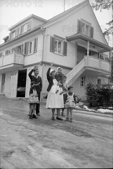 Tibetan refugees waving outside Appenzell house, Waldstatt 1962.