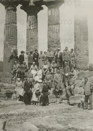 A group of visitors in front of the Temple of the Dioscuri in Agrigento. 1924