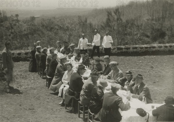 Group lunch outdoors. 
	
		1924