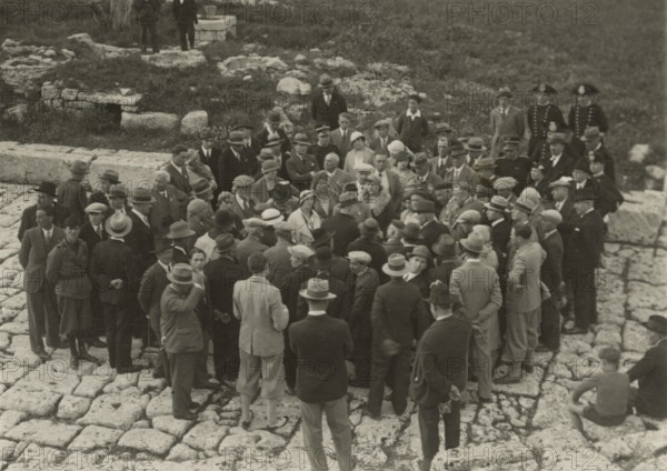 A small group around a guide. 
	
		1924