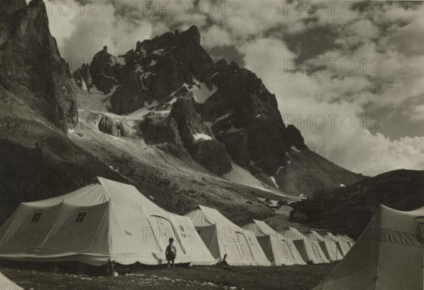 XIV Touring Club Italiano Campsite at the source of the Travignolo: tents at the foot of the Pale di San Martino. 1935