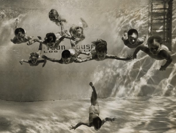 Children training underwater at a swimming school in the United States