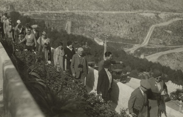 Members of the Touring Club Italiano stopping at a lookout point. 
	
		1924