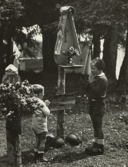 Touring Club campsite at the Pale di San Martino: two children at the camp altar. 1951