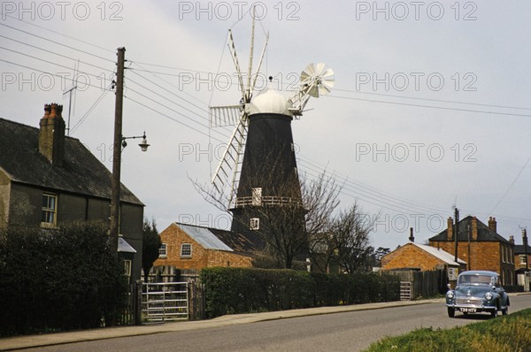 Historic windmill with Morris Minor car, Heckington, Lincolnshire, England, UK early 1960s also known as Pocklington's Mill.