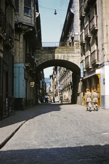 Soldiers walking along historic cobbled street in Old Town, Parte Vieja, San Sebastian, Donostia‚ San Sebastian, northern Spain 1959.