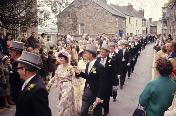 Flora Day, Helston, Cornwall, England, UK 1973 - crowds watch couples perform the  Furry dance in the streets of the town.