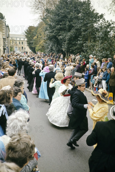 Flora Day, Helston, Cornwall, England, UK 1973 - crowds watch couples perform the  Furry dance in the streets of the town.