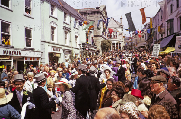 Flora Day, Helston, Cornwall, England, UK 1973 - crowds watch couples perform the  Furry dance in the streets of the town.
