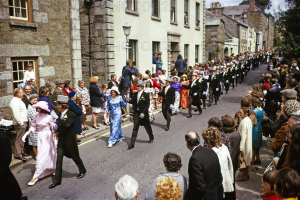 Flora Day, Helston, Cornwall, England, UK 1973 - crowds watch couples perform the  Furry dance in the streets of the town.
