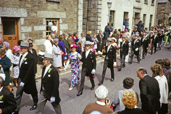 Flora Day, Helston, Cornwall, England, UK 1973 - crowds watch couples perform the  Furry dance in the streets of the town.