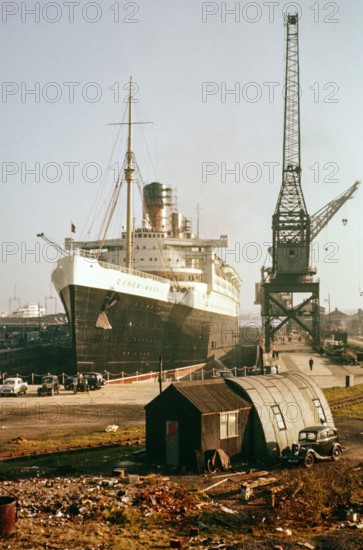 RMS Queen Mary ocean liner ship in dry dock, Southampton docks, Hampshire, England, UK 1950s.