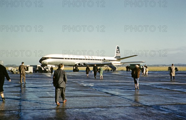 Passengers walking to board BOAC British Overseas Airways Corporation, De Havilland 106 Comet 4 jetliner plane, G-APDB,  early 1960s.