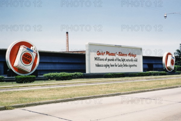 Lucky Strike cigarette advert, Philip Morris tobacco factory, thought to be Durham, North Carolina. USA c 1953.