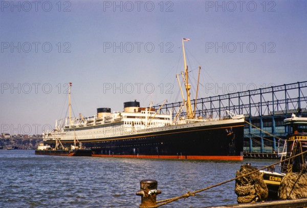 MV Britannic ocean liner Cunard Lines ship East River, Manhattan, New York, NY State, USA, c 1954.