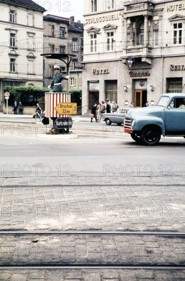 Traffic policeman in street in front of hotels, Bergheimer Strasse, Heidelberg, Baden-Württemberg, Germany, Europe, 1959.