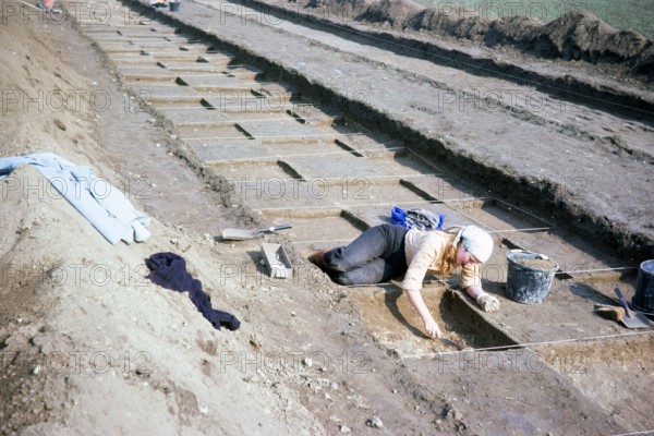 Archaeological excavation of neolithic causewayed enclosure, Great Wilbrahim, Cambridgeshire, England, UK 1976 - stripping a string grid.