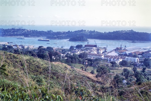 View to port docks of Keppel Harbour from Mount Faber, Singapore, southeast Asia, 1965 - Sentosa Island beyond.