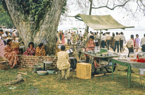 People celebrating having picnics, Waterfront, Johor Bahru, Malaysia, Southeast Asia 1963 - Mawlid festival commemorating the birthday of Islamic prophet Muhammad.
