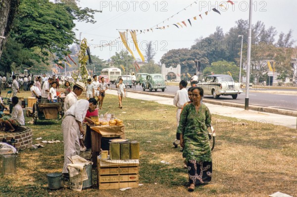People celebrating having picnics, Waterfront, Johor Bahru, Malaysia, Southeast Asia 1963 - Mawlid festival commemorating the birthday of Islamic prophet Muhammad.