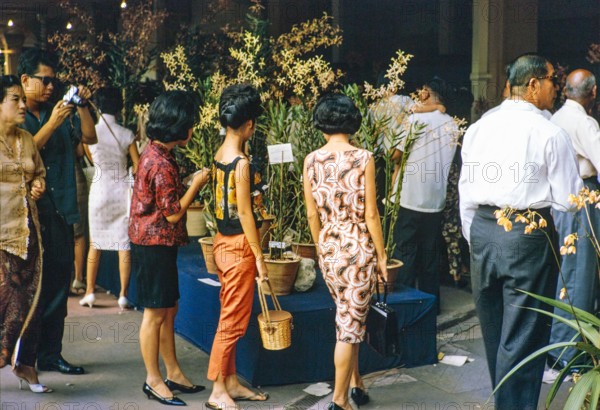 People attending flower show at the Singapore Turf Club, The 4th World Orchid Conference, Singapore, Southeast Asia, October 3-10, 1963.