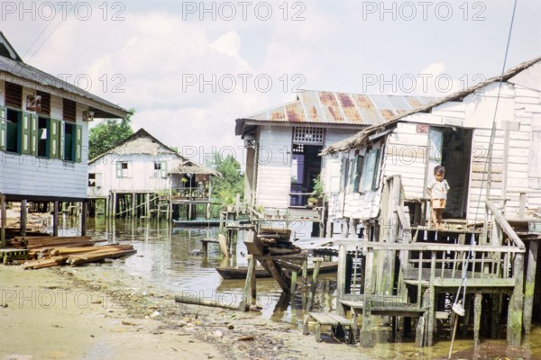 Village Kampong Lorong Fatimah near the Causeway between Singapore and Johor Bahru, Malaysia, Southeast Asia 1964.