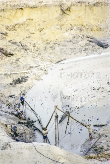 Open Cast gravel-pumping tin mine Malaya, Malaysia, south east Asia 1964 -  high pressure water cannon jet spray to wash out sediment into a slurry.