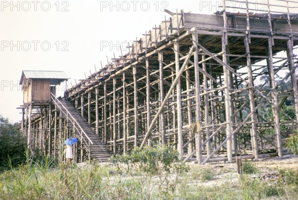 Open Cast gravel-pumping tin mine Malaya, Malaysia, south east Asia 1964 -  pumping raises the slurry from the sump to an elevated wooden sluice level called a palong.