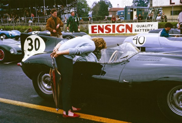 Whitsun Sports car race 3 June 1963, John Coundley in Jaguar D-type car on start line, Goodwood, England, UK, his wife Pat leaning over.