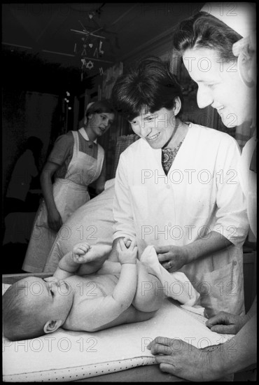 Mother changing baby's nappies, 1969